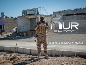 A portrait of a member of the Iraqi autonomous Kurdish region's peshmerga forces arrives to inspect the liberated city of Sinjar, on Novembe...