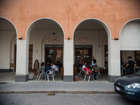 A café bar in the monumental Piazza della Repubblica, formerly Piazza della Rivoluzione, built in a characteristic D-shape, in Tresigallo, i...