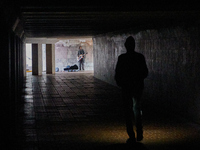 A man walks through an uniluminated underground passage on European Square in Kyiv, October 24, 2022 (