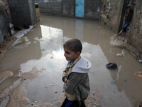 A Palestinian boy walks in a flooded street during a rainy day in Gaza city on November 17, 2015. (
