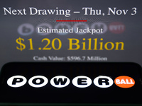 Powerball logo displayed on a phone screen and PowerBall website displayed on a laptop screen are seen in this illustration photo taken in K...