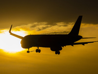 Aircraft silhouette, a symbol illustration photo during the magic hour of an arriving passenger plane for landing at Eindhoven Airport. Dusk...