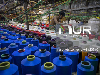 Workers manufacture thread for Ready-Made Garment Industry in a textile mill in Narsingdi outskirts of Dhaka, Bangladesh on November 02, 202...
