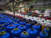 Workers manufacture thread for Ready-Made Garment Industry in a textile mill in Narsingdi outskirts of Dhaka, Bangladesh on November 02, 202...