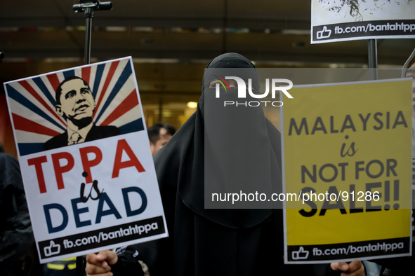 during a protest rally against Trans-Pacific Partnership Agreement (TPPA) ahead of U.S. President Barack Obama's Malaysia visit in Kuala Lum...