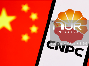 China National Petroleum Corporation logo displayed on a phone screen and Chinese flag displayed on a screen in the background are seen in t...