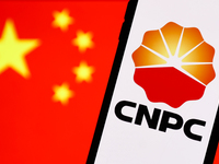 China National Petroleum Corporation logo displayed on a phone screen and Chinese flag displayed on a screen in the background are seen in t...
