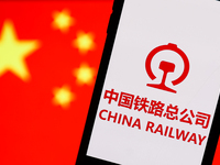 China Railway logo displayed on a phone screen and Chinese flag displayed on a screen in the background are seen in this illustration photo...