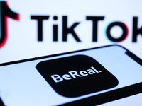 BeReal logo displayed on a phone screen and TikTok logo displayed on a laptop screen are seen in this illustration photo taken in Krakow, Po...