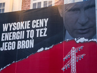 A big banner with a picture of Vladimir Putin and a slogan 'High energy prices are also his weapon' is seen on an appartment house in Krakow...