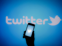 The Twitter logo is seen on a handheld mobile device in this photo illustration in Warsaw, Poland on 06 November, 2022. In a series of messa...