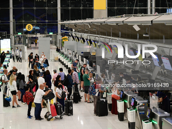 Travelers seen queue in line to check-in for flight at Suvarnbhumi International Airport on November 9, 2022 in Sumut Prakan, Thailand. (