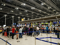 Travelers queue in line to check-in for flight at Suvarnbhumi International Airport on November 9, 2022 in Sumut Prakan, Thailand. (