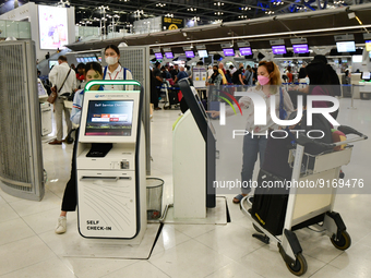 Travelers seen check-in for flight by Auto Check-in System  inside the departure terminal of the Suvarnabhumi International Airport on Novem...