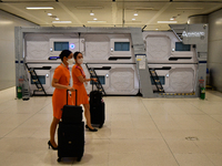 Cabin crews seen push their luggage walk past the boxtel near the departure terminal of the Suvarnabhumi International Airport on November 9...