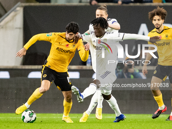 Wolvess Gonalo Guedes and Leeds United's Darko Gyabi battle for the ball during the Carabao Cup match between Wolverhampton Wanderers and Le...