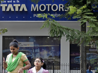 People walks past Tata Motors showroom in Mumbai, India, 10 November, 2022. Tata Motors shares fall over 4% post Q2 earnings according to an...