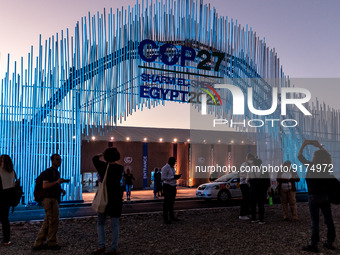 Participants stand in front of the main entrance of COP27 venue on the fourth day of the COP27 UN Climate Change Conference, held by UNFCCC...