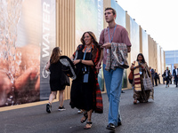 Participants walk in the Delegation Pavilion area on the fourth day of the COP27 UN Climate Change Conference, held by UNFCCC in Sharm El-Sh...