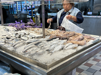 Woman purchasing squid at a grocery store in Mississauga, Ontario, Canada on November 11, 2022. The majority of respondents in a Canada-wide...