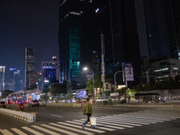 Man walk at pelican crossing in Jakarta on 13 November 2022. Indonesia's economy expanded at its fastest pace in more than a year in the thi...