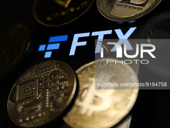 FTX logo displayed on a phone screen and representation of cryptocurrencies are seen in this illustration photo taken in Krakow, Poland on N...