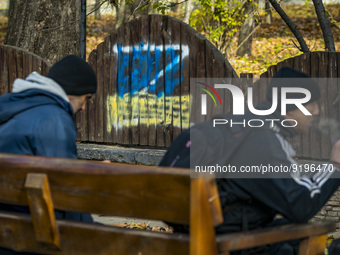 A graffiti with a Z symbol in support of the russian occupation in Ukraine, is covered by an ukrainian flag painting in a park of Kherson ci...