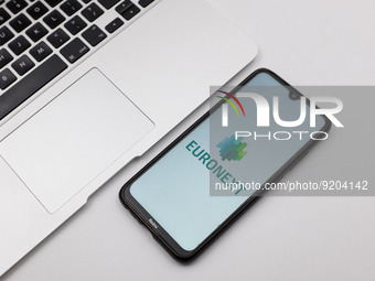 In this photo illustration an Euronext N.V. logo seen displayed on a smartphone screen on a desk next to a Macbook in Athens, Greece on Nove...