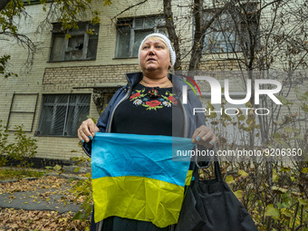 A woman holds an ukrainian flag in support of the army forces of Ukraine in the streets of Kherson, a recent liberated city of the russian o...