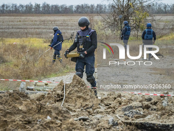 A mine deactivator carries an anti-tank mine discovered in the fields in the outskirts of Kherson after the russian retreat of the city, cur...
