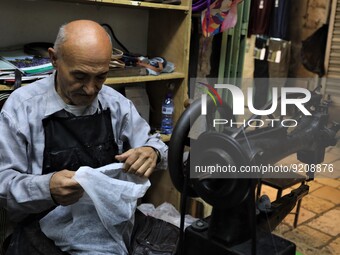Shoe mender Nabil Khuraim performs his craft in Jerusalem on November 17, 2022. Known to be the oldest shoe mender in Jerusalem, 72 year old...