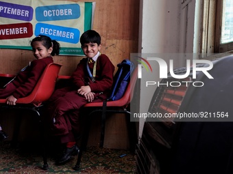Students read inside a class room as heating facilities are installed at Ahmed public school in Baramulla Jammu and Kashmir India on 18 Nove...