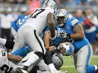 Detroit Lions quarterback Matthew Stafford (9) gets sacked by Oakland Raiders defensive tackle Stacy McGee (92) during the third quarter of...