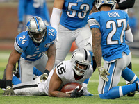 Oakland Raiders wide receiver Michael Crabtree (15) is tackled by Detroit Lions cornerback Nevin Lawson (24) during the second half of an NF...