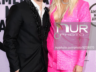 Chris Olsen and Meghan Trainor arrive at the 2022 American Music Awards (50th Annual American Music Awards) held at Microsoft Theater at L.A...
