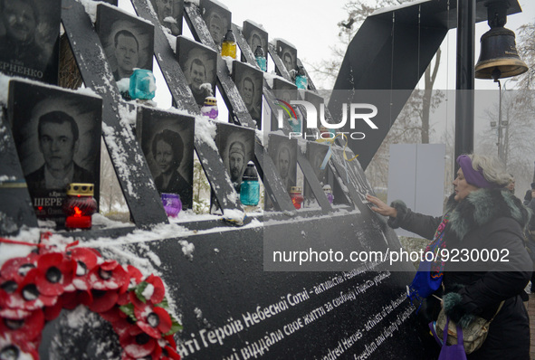KYIV, UKRAINE - NOVEMBER 21, 2022 - A woman faces the Heavenly Hundred Heroes memorial during an event to pay tribute to the perished activi...