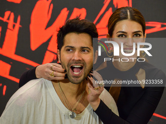Bollywood actress Kriti Sanon (right) and actor Varun Dhawan (left) react as they speak to the media during a promotional event of their upc...