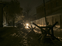 Street with anti-tank obstacle defense during a blackout after a Russian missile attack on Ukrainian power infrastructure in Kyiv, Ukraine,...