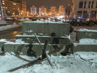 Graffiti by artist Banksy with anti-tank obstacle defense  at the Independence Square in center of Kyiv, Ukraine, November, 2022 (