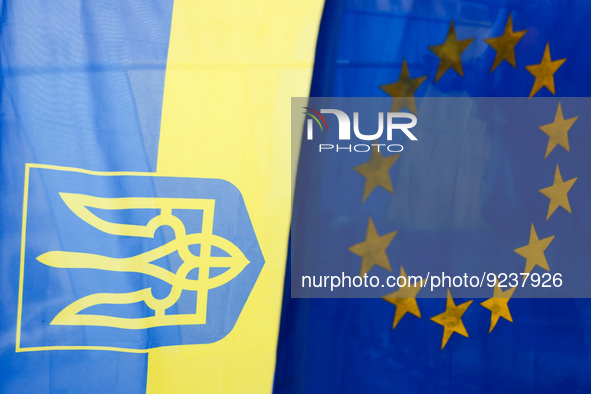 Ukrainian ans EU flags are seen on an everyday demonstration of solidarity with Ukraine at the Main Square, on the 273rd day of Russian aggr...