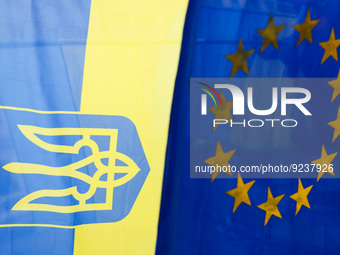 Ukrainian ans EU flags are seen on an everyday demonstration of solidarity with Ukraine at the Main Square, on the 273rd day of Russian aggr...