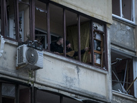 Residents of an apartment building demaged by a Russian missile attack clean their apartments after the explosion in the Vyshhorod town, nea...
