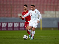 Portugal U19 player Gonçalo Esteves (R) runs with the ball during the Preparatory Friendly Tournament U19 2023 soccer match between Malta...