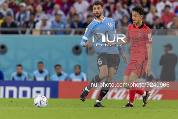 Rodrigo Bentancur , Jaesung Lee  during the World Cup match between Uruguay v Korea Republic in Doha, Qatar, on November 24, 2022. 