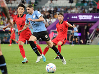 Federico Valverde of Uruguay, Hwang In-Beom of South Korea (L) during the FIFA World Cup 2022, Group H football match between Uruguay and Ko...