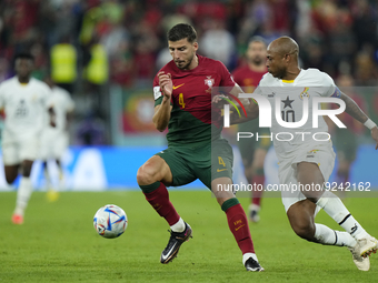 Ruben Dias Centre-Back of Portugal and Manchester City and Andre Ayew Left Winger of Ghana and Al-Sadd SC during the FIFA World Cup Qatar 20...