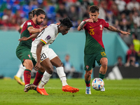 (18) RUBEN NEVES and (25) OTAVIO of Portugal team battel on ball with (20) KUDUS Mohammed of Ghana team during FIFA World Cup Qatar 2022  Gr...