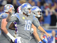 Detroit Lions quarterback Jared Goff (16) signals a two-point conversion play during the second half of an NFL football game between the Det...
