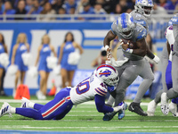 Detroit Lions running back Jamaal Williams (30) is tackled by Buffalo Bills linebacker Von Miller (40) during the first half of an NFL footb...