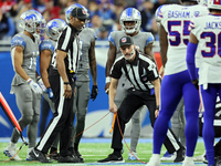 Down judge Dana McKenzie (8) checks the yard marker chain during an NFL football game between the Detroit Lions and the Buffalo Bills in Det...